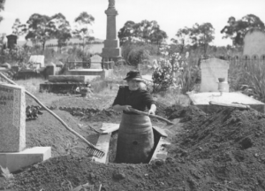 woman digging up grave in 1944