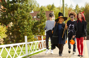 teenagers on bridge trick or treating on Halloween in costumes