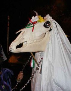 A horse skull on a stick called the Mari Lwyd is shown as a Welsh Christmas tradition