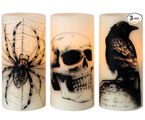 three Halloween candles show a spider, skill and raven